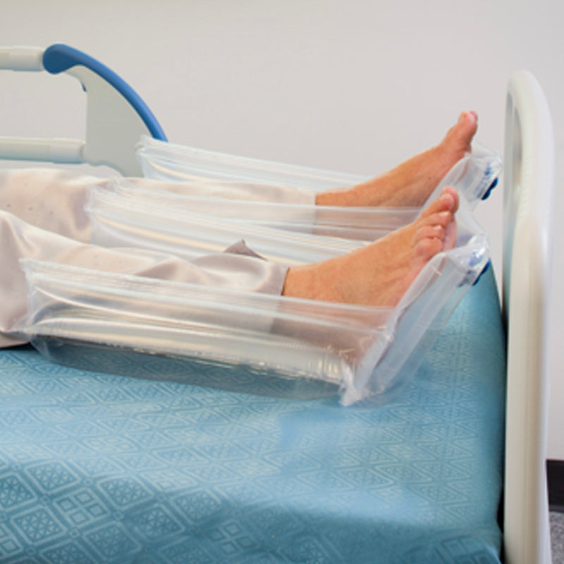 Female patient lying in bed. Side view of feet and calves supported in a pair of Repose Foot Protectors. 