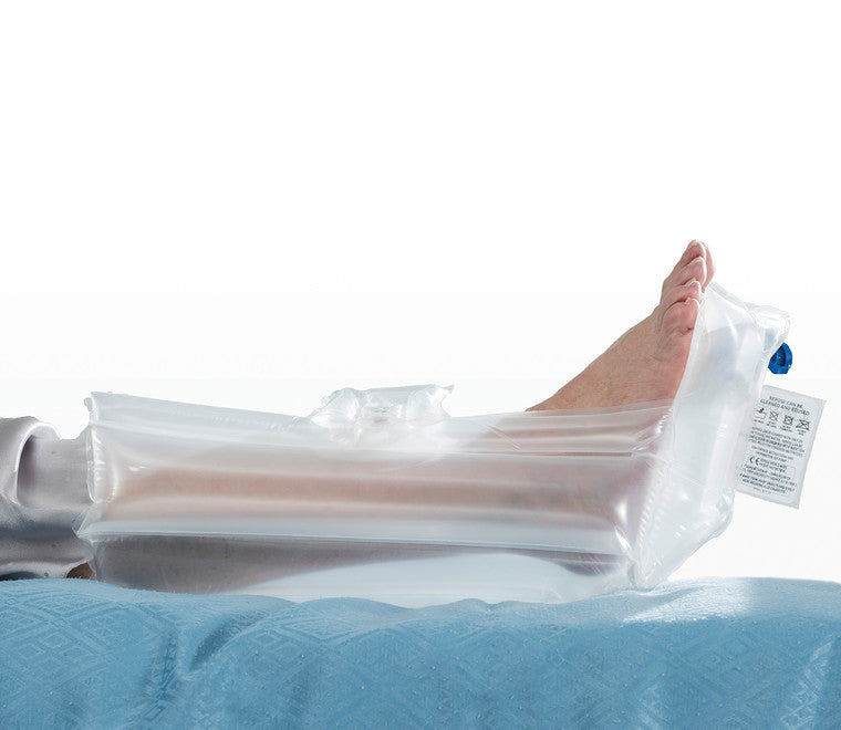 Side view of a calf and foot, supported on a Repose Foot Protector Plus. the label and valve are seen at the base of the foot.  The leg and foot look like they are floating off the bed.