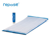Repose Mattress Overlay without a cover is lying flat alongside a Repose Pump.